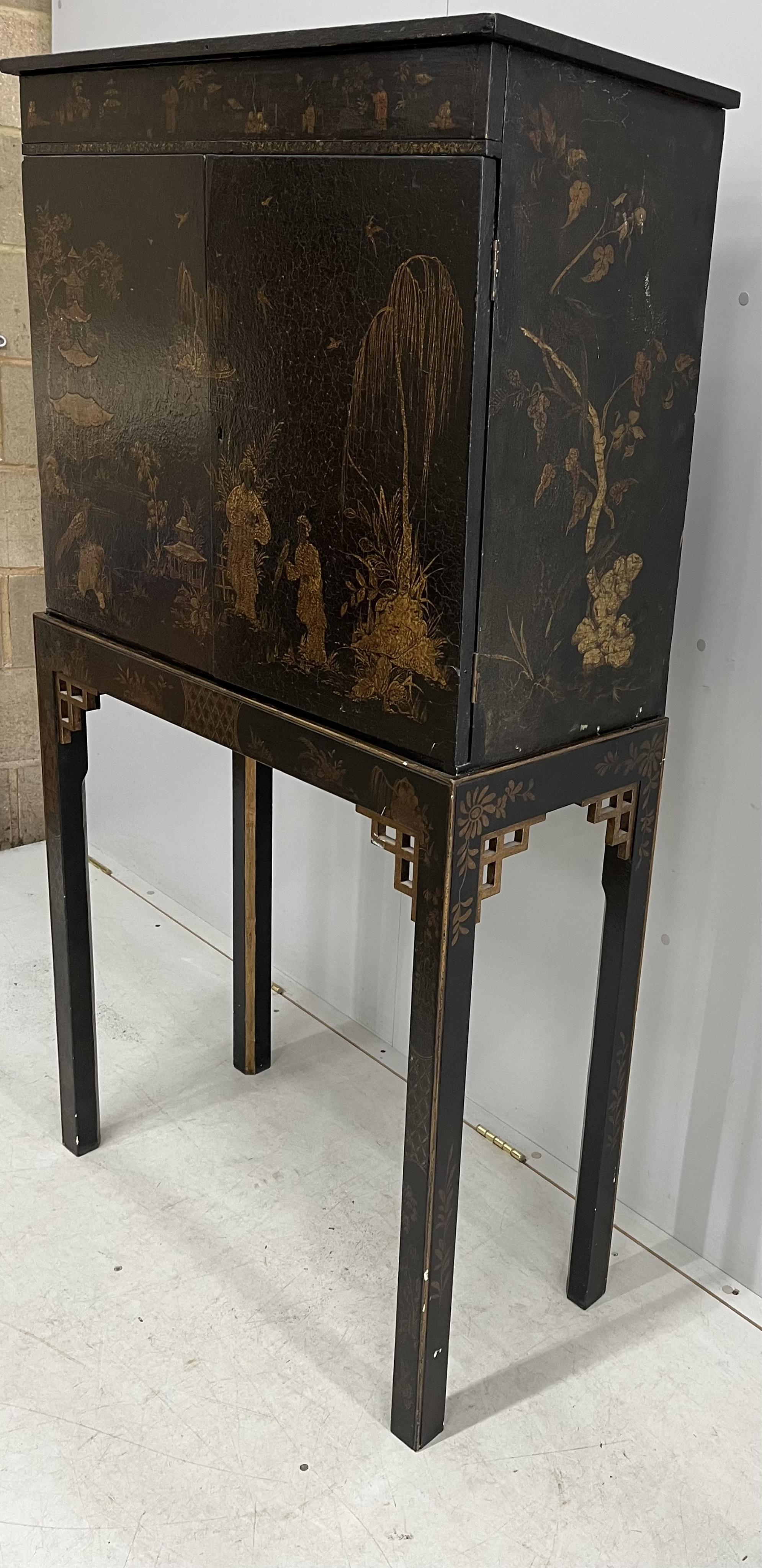 A chinoiserie lacquered cabinet on stand, width 82cm, depth 36cm, height 152cm. Condition - fair